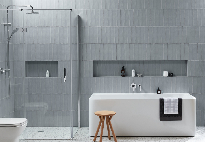 Image of a bathroom displaying Domaine fittings and products: a bath, a shower, a stool, wall tiles and more.
