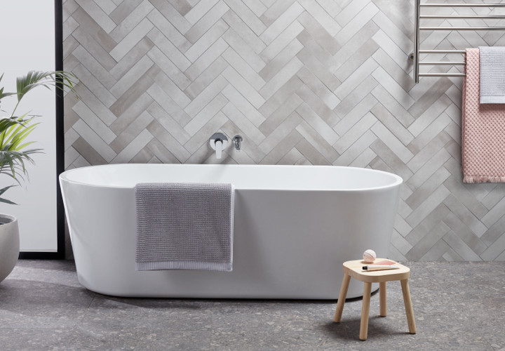 Image of a bathroom displaying Solus fittings and products: a bath, a stool, wall tiles and more.